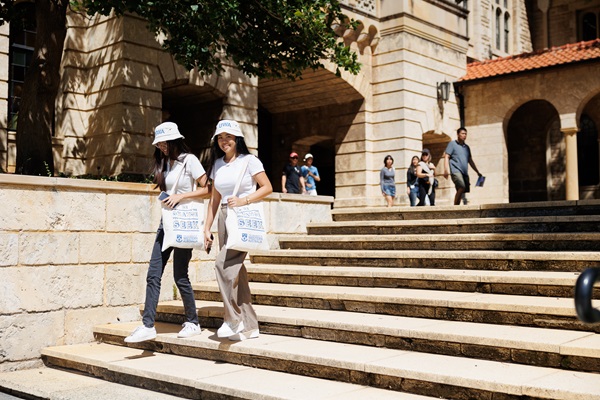 Image of two students walking past Winthrop Hall
