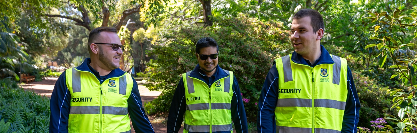 3 security guards walking through campus