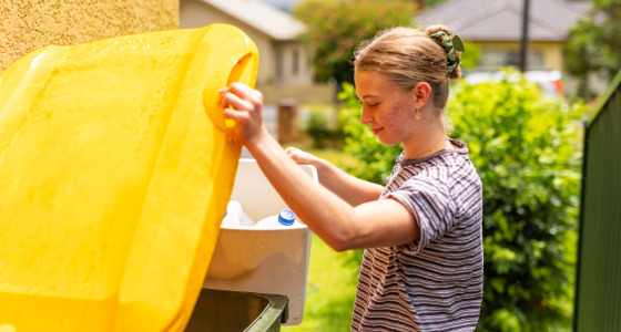 Woman adding waste to recycling bin