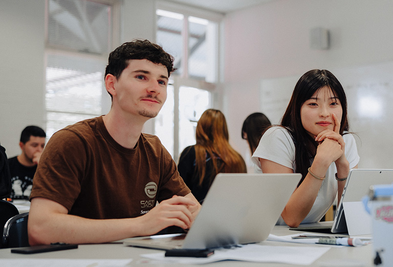 UWA CELT students in a classroom with laptops