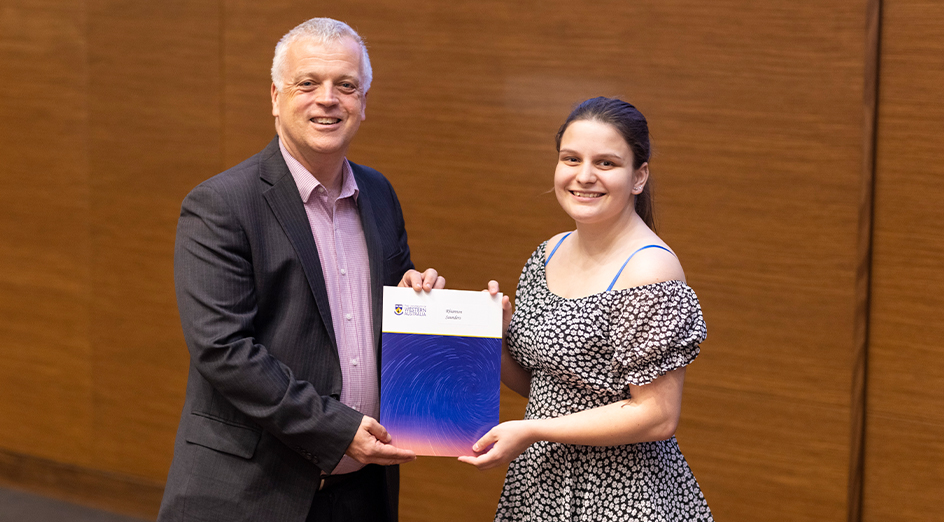 Rhiannon Saunders accepts her certificate from Professor David Sadler