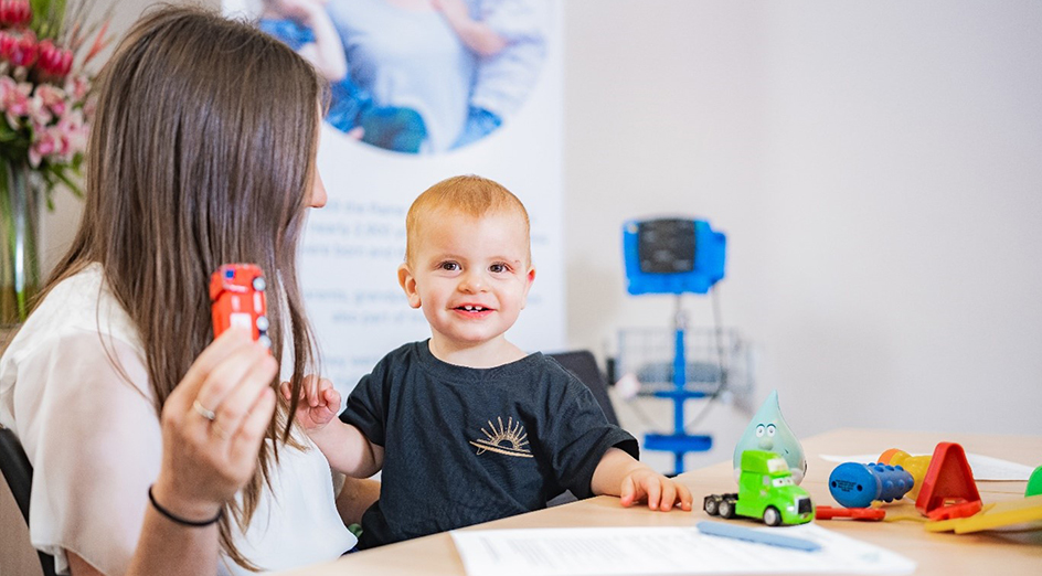 Raine Study third-generation toddler with researcher