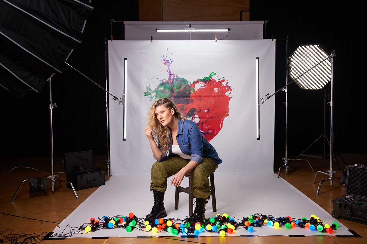 Artist sitting in front of their work