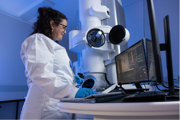 Researcher standing at Microscopy instrument