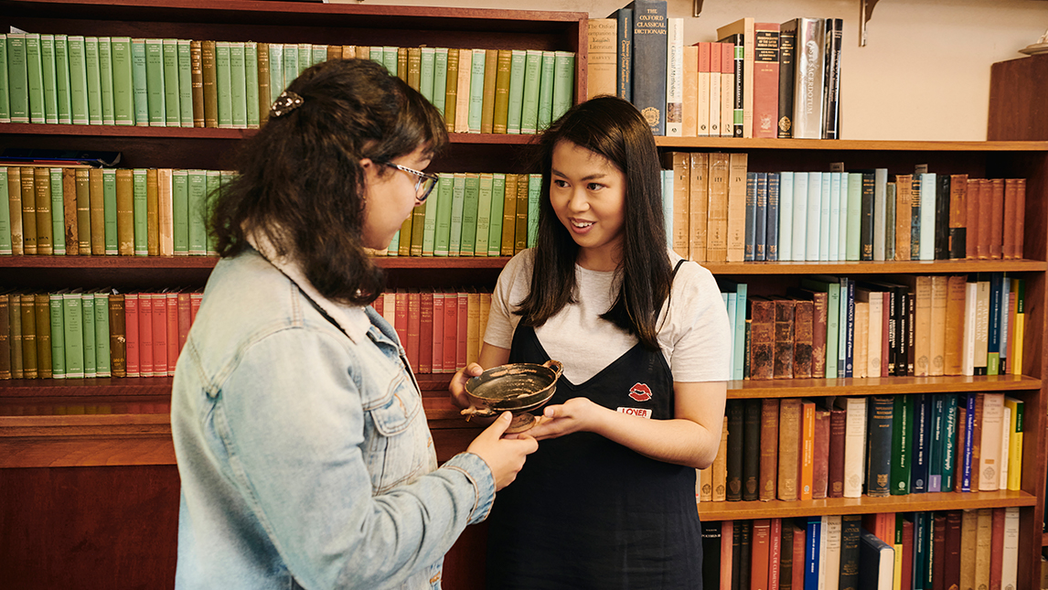 Two students examining a bowl 