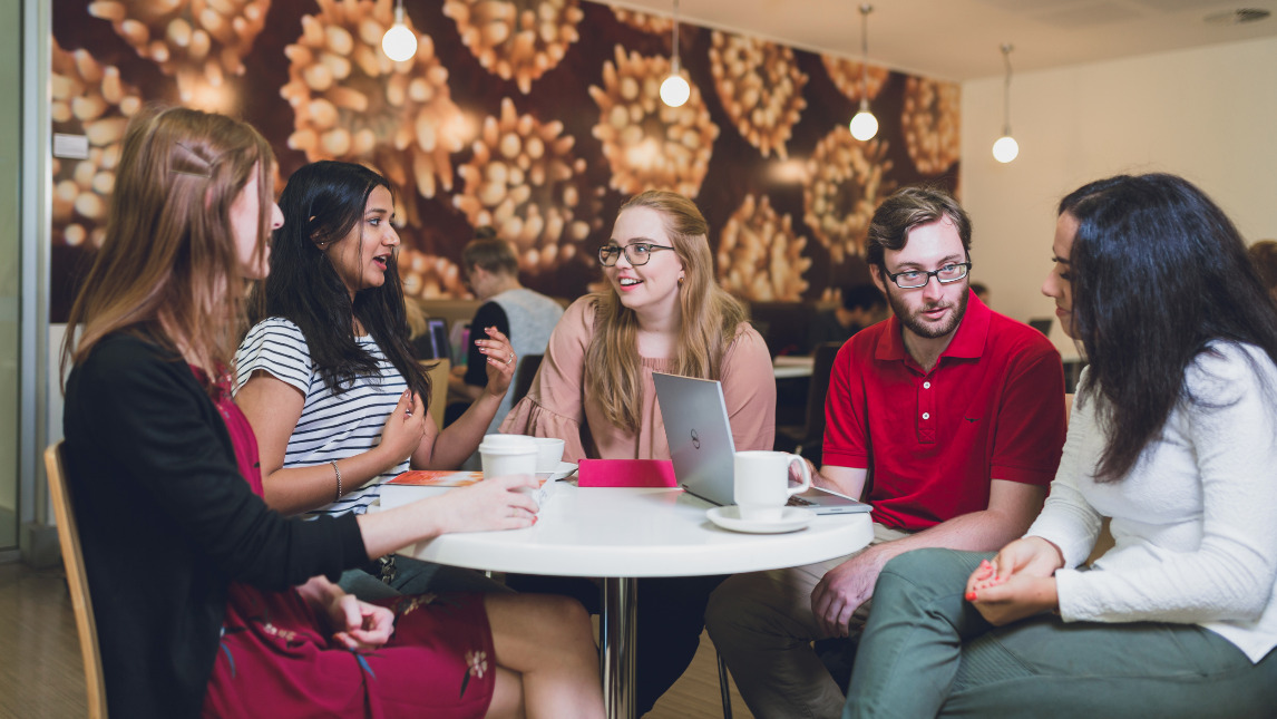 Students gathered around at a cafe