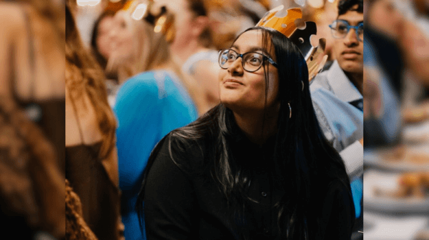 International student, Urmila, sitting at an awards night