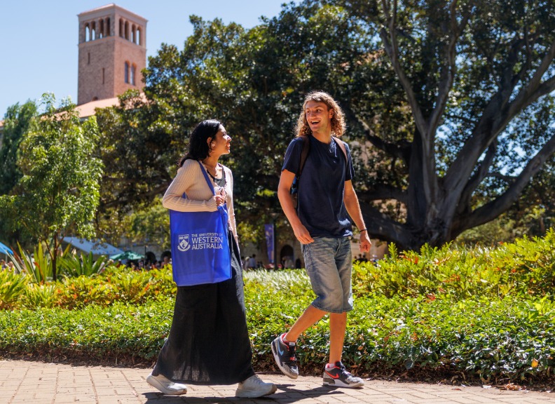 two students walking through campus