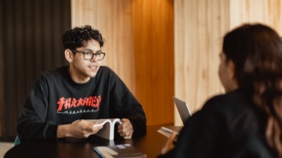 Student sitting at table with open book