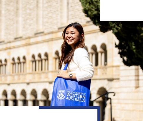 Student with UWA branded bad standing in front of Winthrop Hall