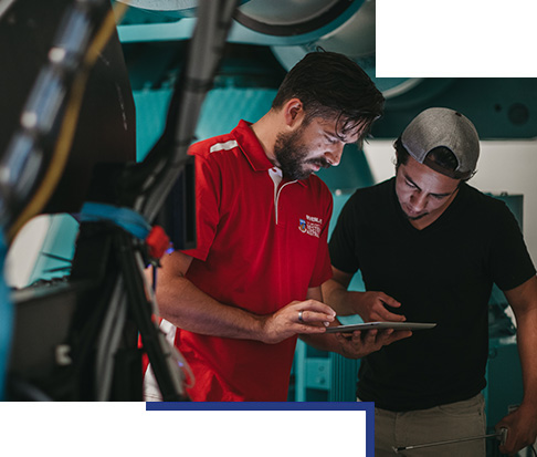 2 students looking at an ipad in a lab